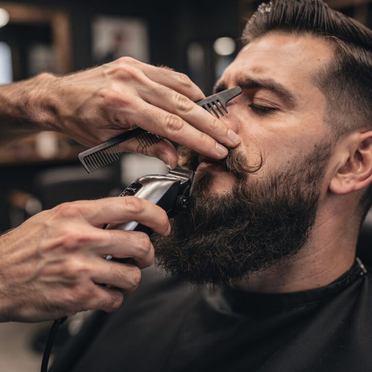 flux pro 2.0 close up of barber grooming a beard with precision using trimmer and comb clean 0