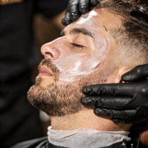 flux pro 2.0 extreme close up of a barber applying a facial treatment to a client focus on sk 0